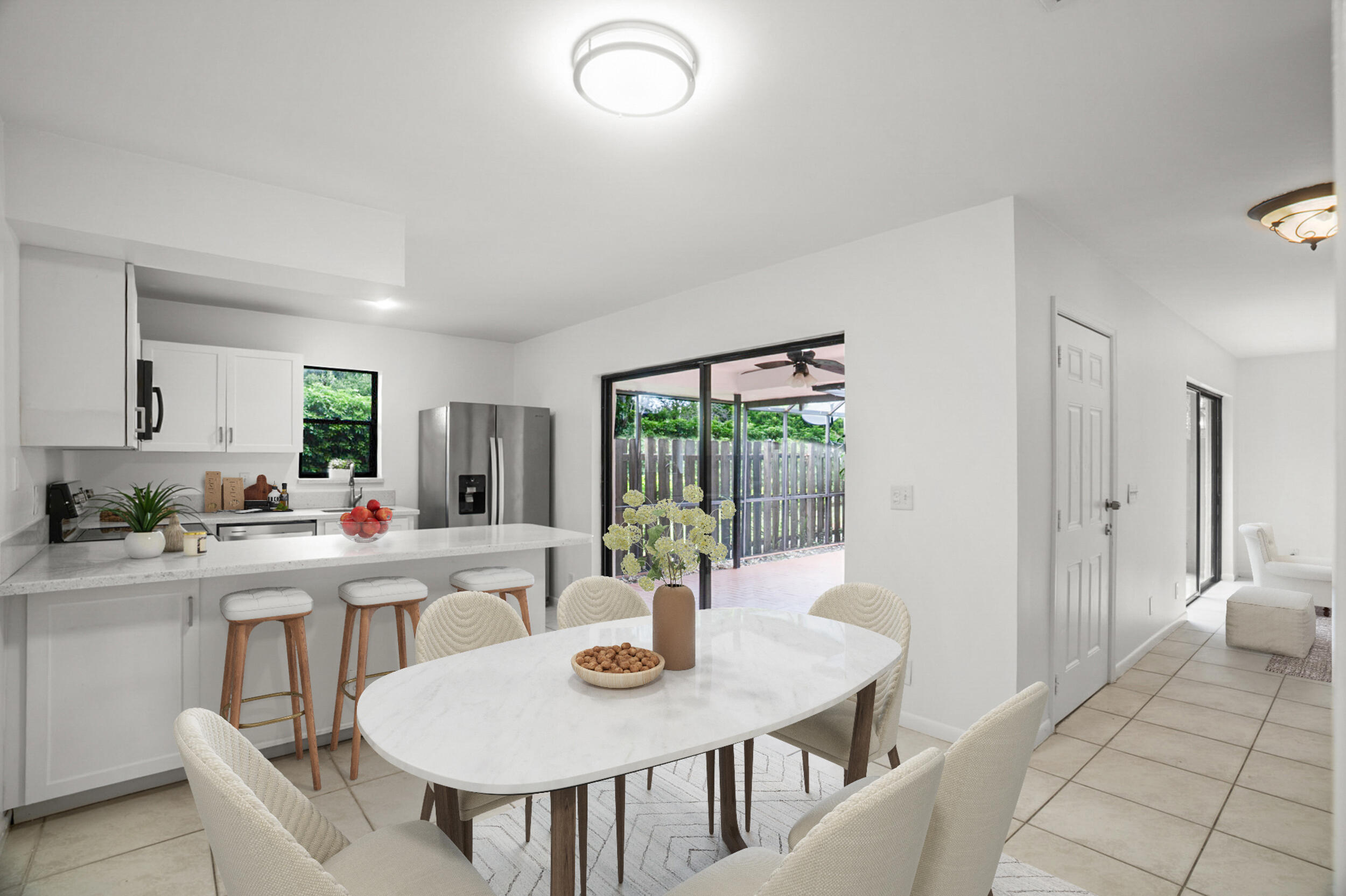 7690 Courtyard Run West Boca Raton, FL 33433 - Photo 5 of 22 a view of a dining room and kitchen with a table and chairs