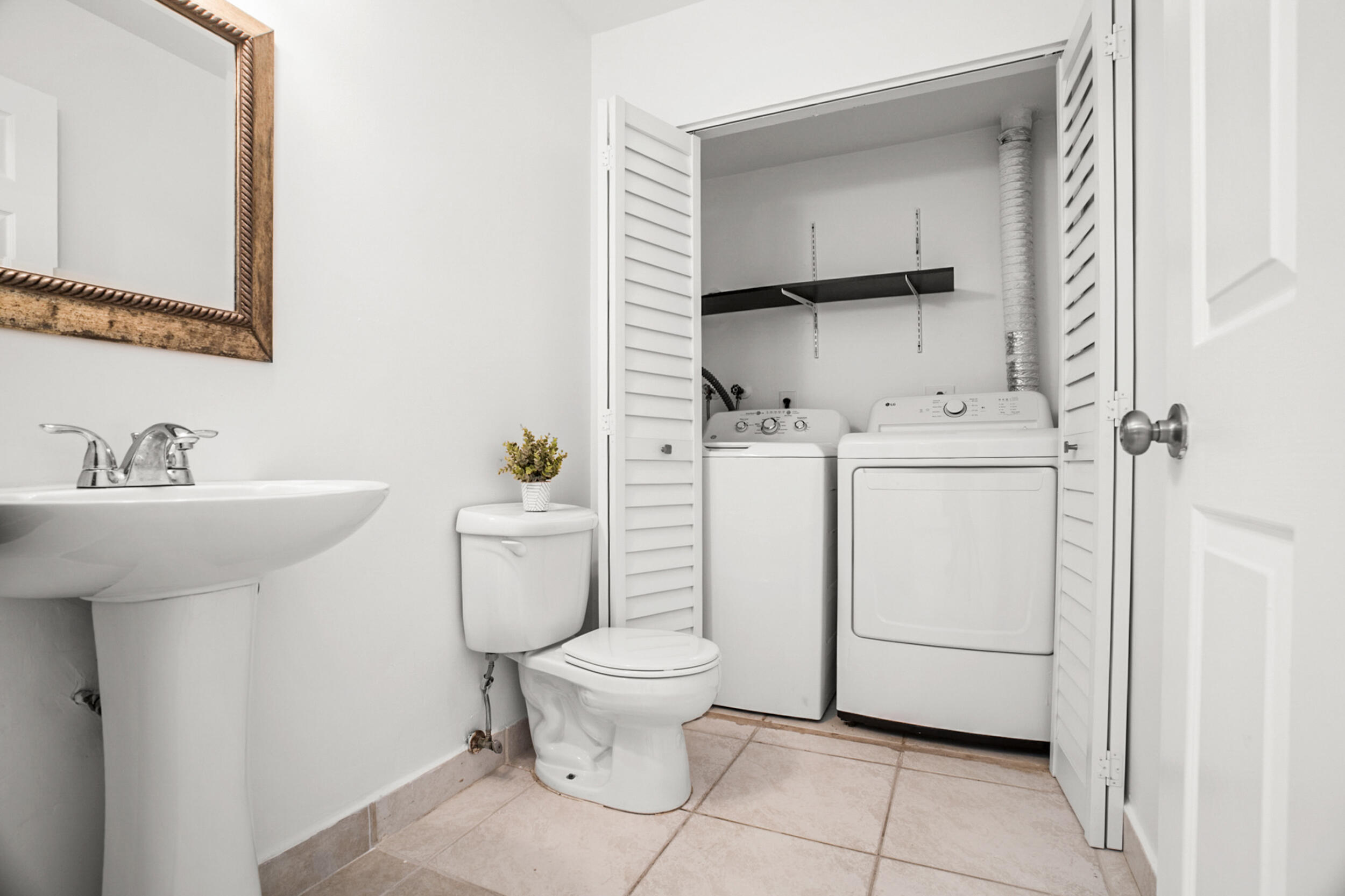 7690 Courtyard Run West Boca Raton, FL 33433 - Photo 9 of 22 a bathroom with a sink toilet and mirror