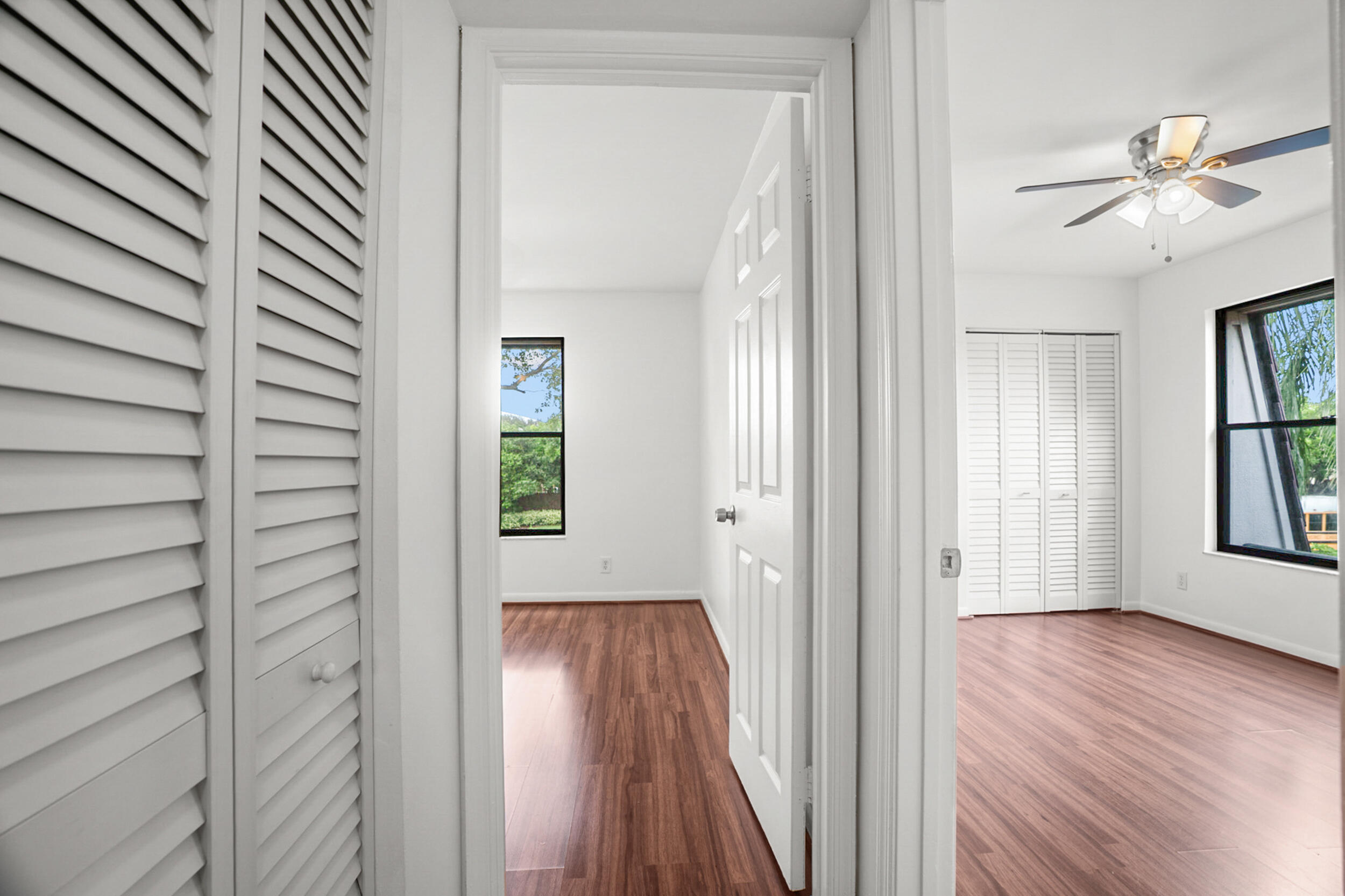 7690 Courtyard Run West Boca Raton, FL 33433 - Photo 10 of 22 a view of a hallway with wooden floor and a window