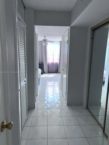 a view of hallway with a window and a mirror