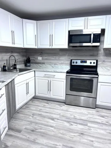 a kitchen with a stove and a microwave