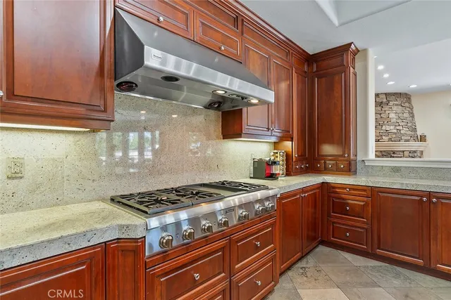 a kitchen with stainless steel appliances granite countertop a stove and a sink