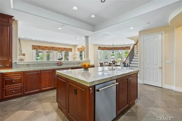 a kitchen with stainless steel appliances granite countertop a sink and a stove