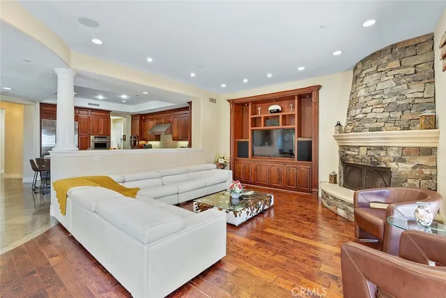 a living room with fireplace furniture and a large window