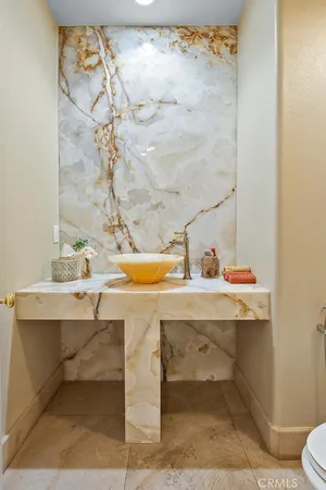 a view of bathroom with a sink and mirror