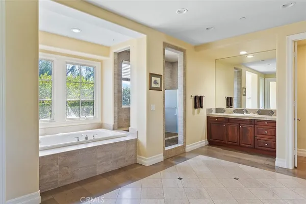 a large spacious bathroom with a large tub shower and sink