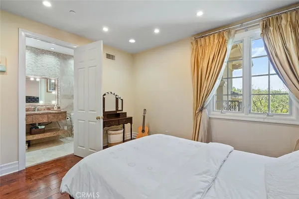 a bedroom with a bed and a large window