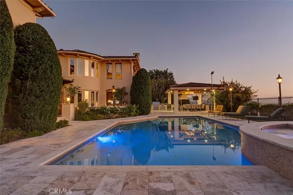 a view of a patio with a table and chairs under an umbrella