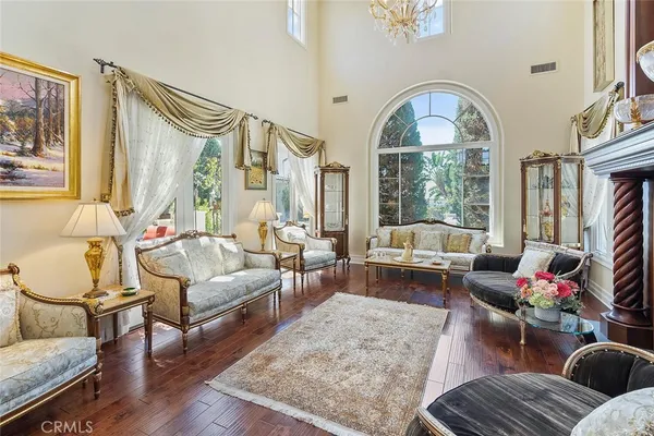 a living room with furniture chess table and a large window