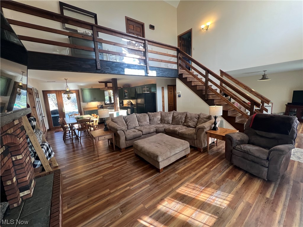 4512 Tabor Ridge Road Northeast Mineral City, OH 44656 - Photo 13 of 44 Living room with french doors, a towering ceiling, and dark hardwood / wood-style flooring