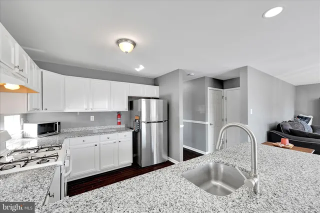 a kitchen with a sink stainless steel appliances and cabinets