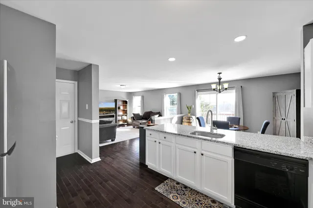 a kitchen with sink stove and refrigerator