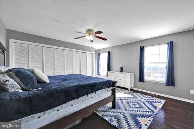 a bedroom with a large bed and a window