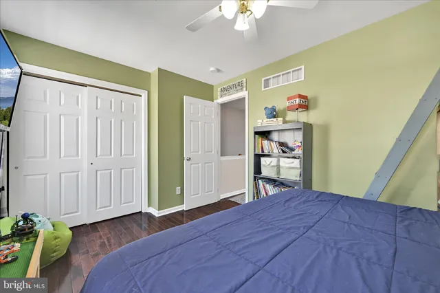 a bedroom with a bed and a dresser