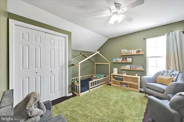 a bedroom with furniture and a ceiling fan