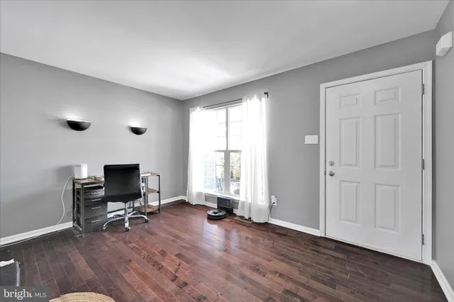 a view of a livingroom with a hardwood and a flat screen tv