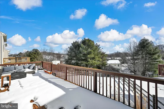 a view of a balcony with dining table and chairs