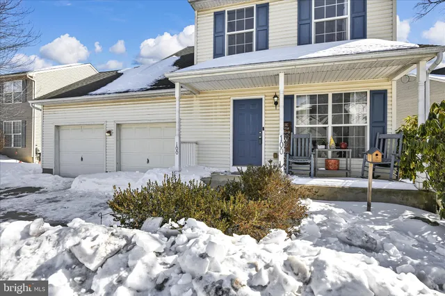 a view of a house with a yard and pathway
