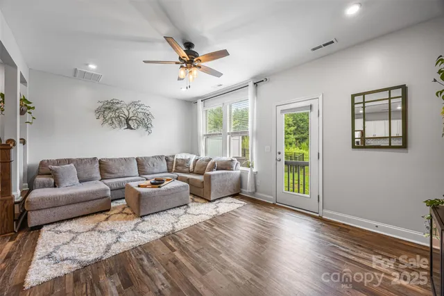 a living room with furniture and kitchen view