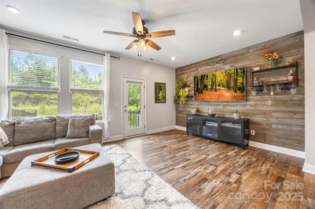 a living room with stainless steel appliances kitchen island granite countertop furniture and a kitchen view