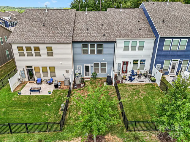 a view of a backyard with chairs and a fire pit