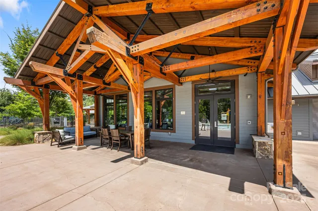 a building outdoor space with patio furniture and potted plants