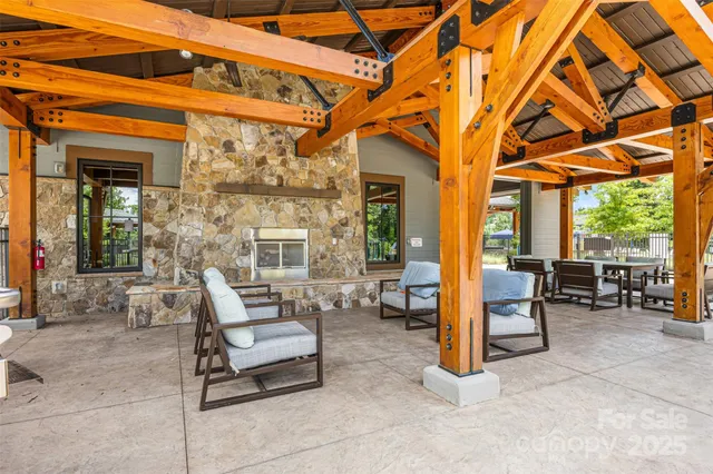 a dining room with wooden floor a chandelier a glass table and chairs