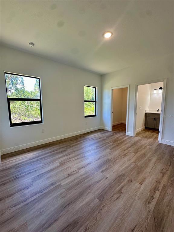 1840 Greenley Road North Port, FL 34286 - Photo 17 of 24 an empty room with wooden floor and windows