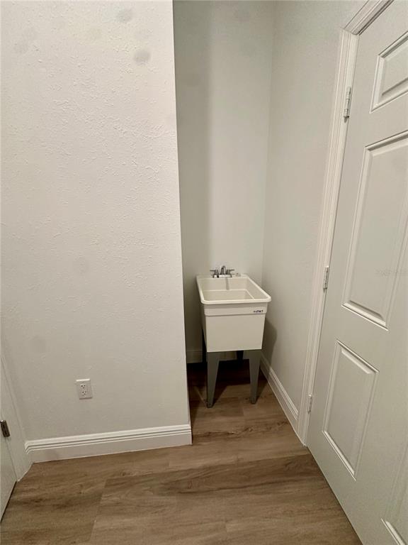 1840 Greenley Road North Port, FL 34286 - Photo 23 of 24 a view of a room with a bench and wooden floor