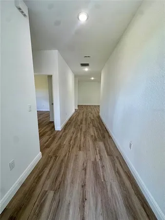 a view of hallway with wooden floor