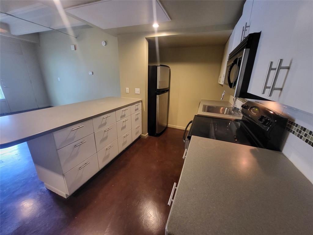 2408 Leon Street, Unit 100 Austin, TX 78705 - Photo 3 of 6 a view of kitchen with furniture and wooden floor