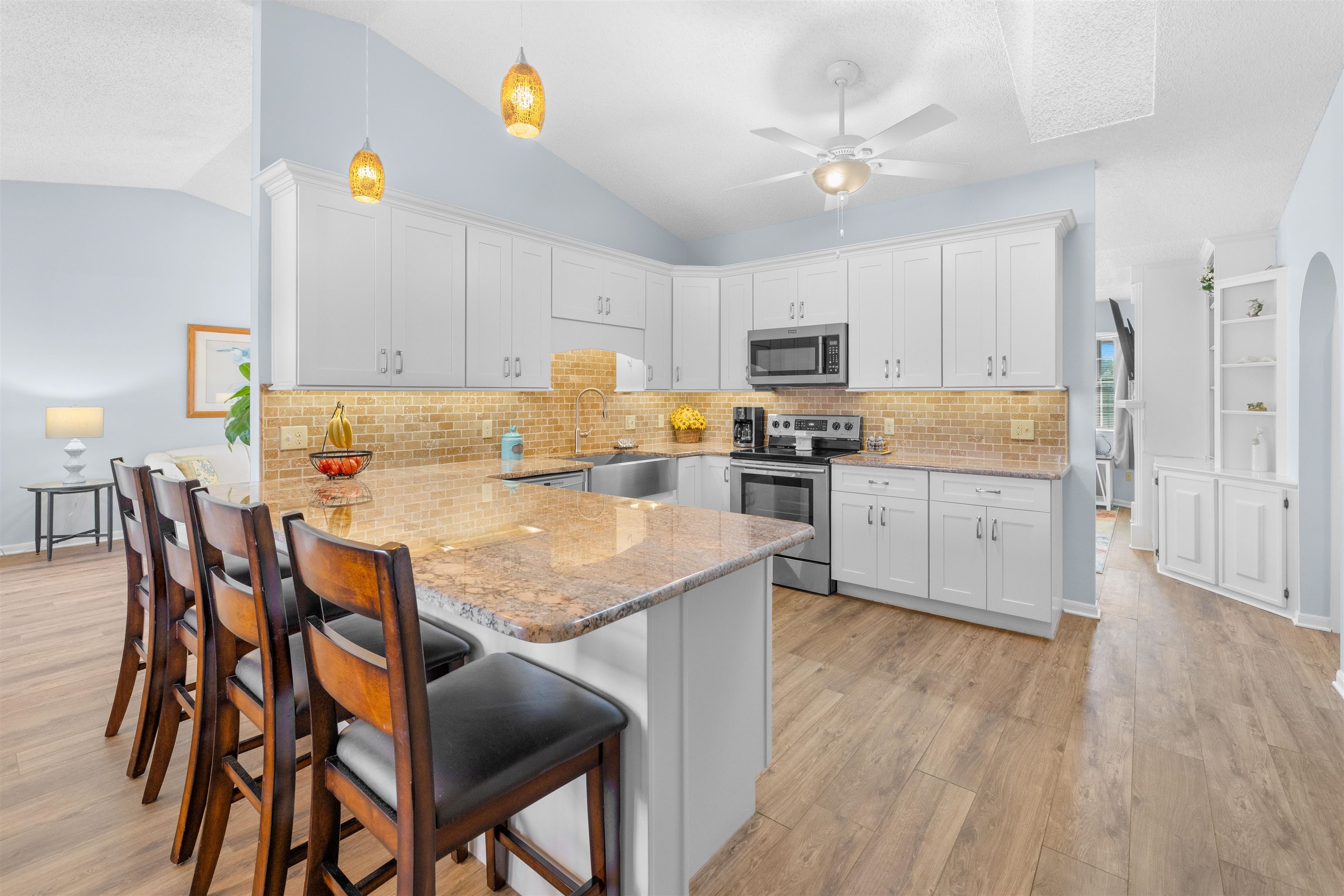 655 East Bianca Circle St. Augustine, FL 32086 - Photo 11 of 53 a kitchen with kitchen island a stove a sink a oven a dining table and chairs