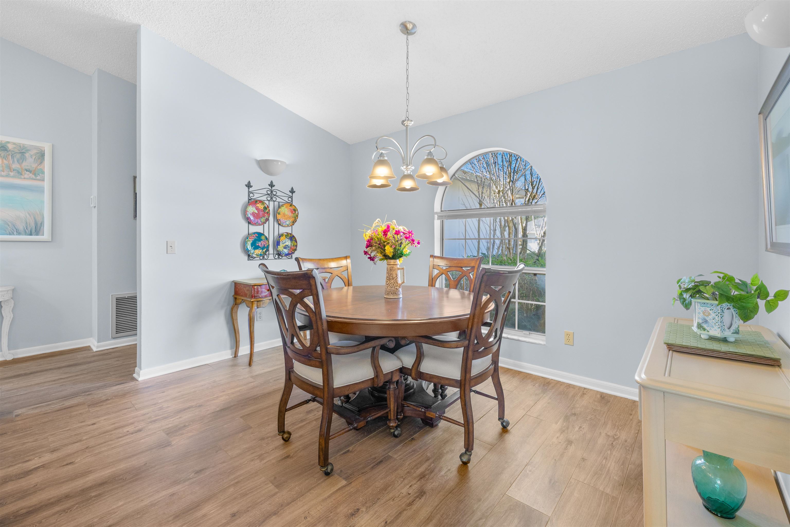 655 East Bianca Circle St. Augustine, FL 32086 - Photo 26 of 53 a dining room with furniture a chandelier and wooden floor