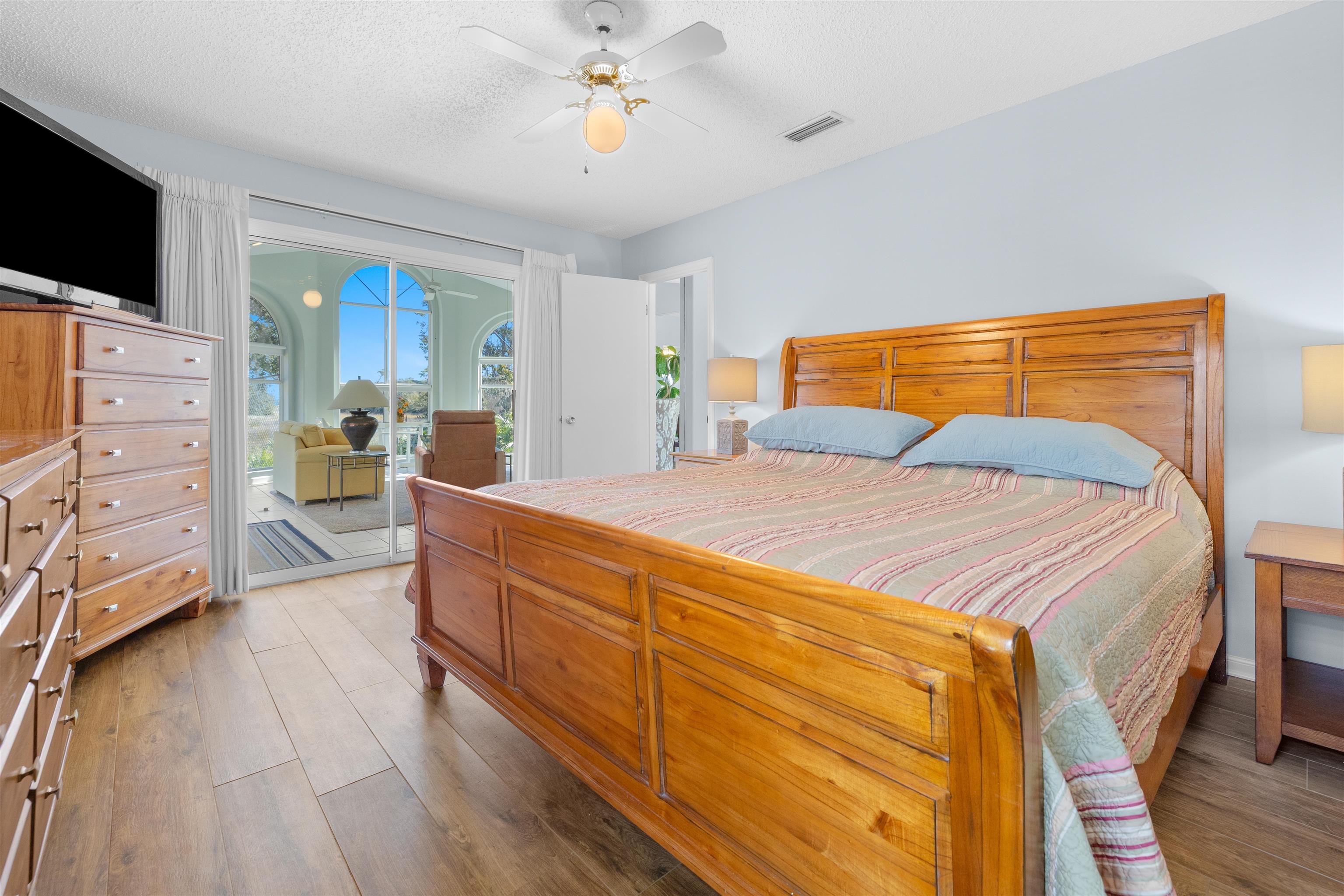 655 East Bianca Circle St. Augustine, FL 32086 - Photo 27 of 53 a bedroom with a bed and wooden floor