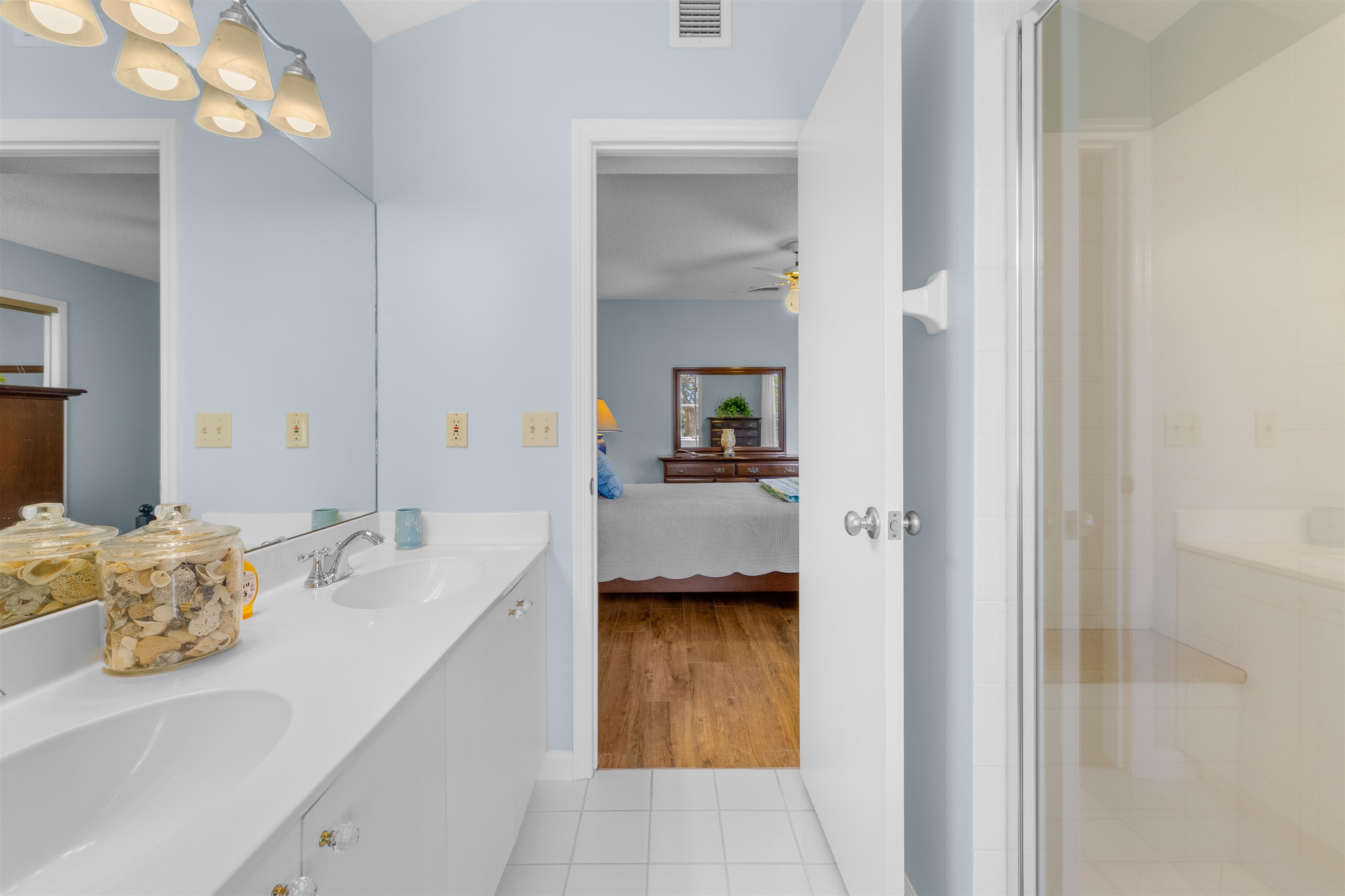 655 East Bianca Circle St. Augustine, FL 32086 - Photo 34 of 53 a en suite bathroom with a granite countertop sink and a mirror