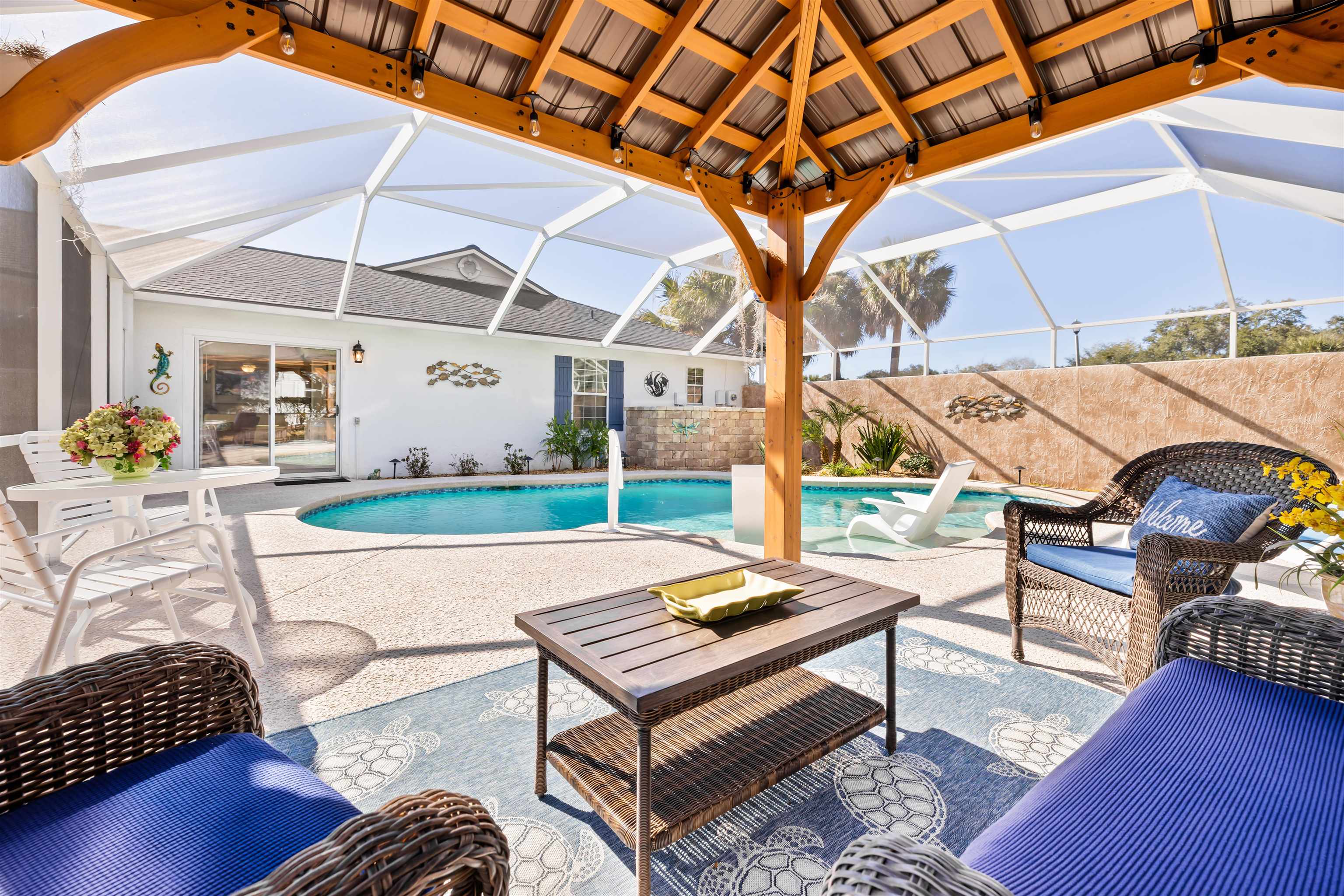 655 East Bianca Circle St. Augustine, FL 32086 - Photo 52 of 53 a outdoor space with lots of white furniture and a rug