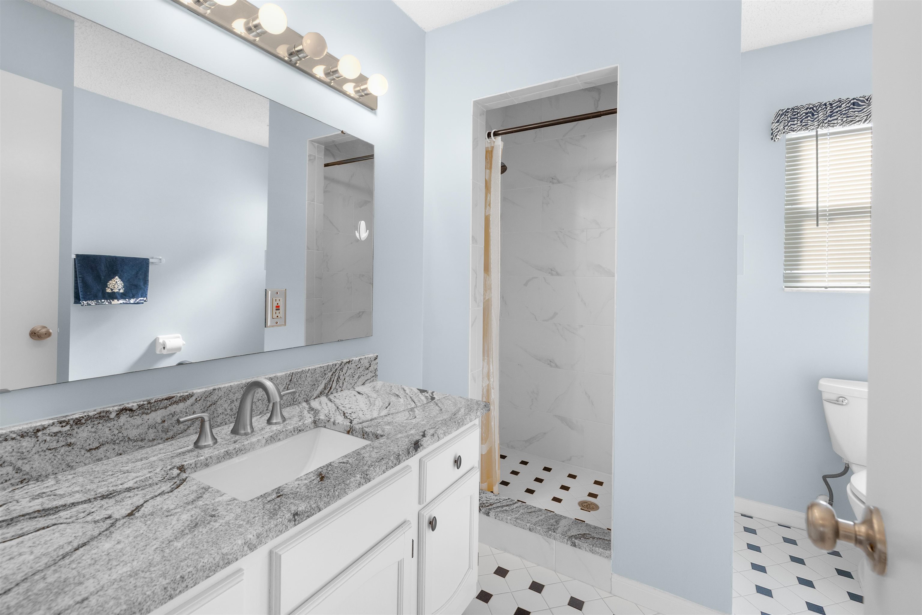 655 East Bianca Circle St. Augustine, FL 32086 - Photo 6 of 53 Full bath with vanity and a marble finish shower