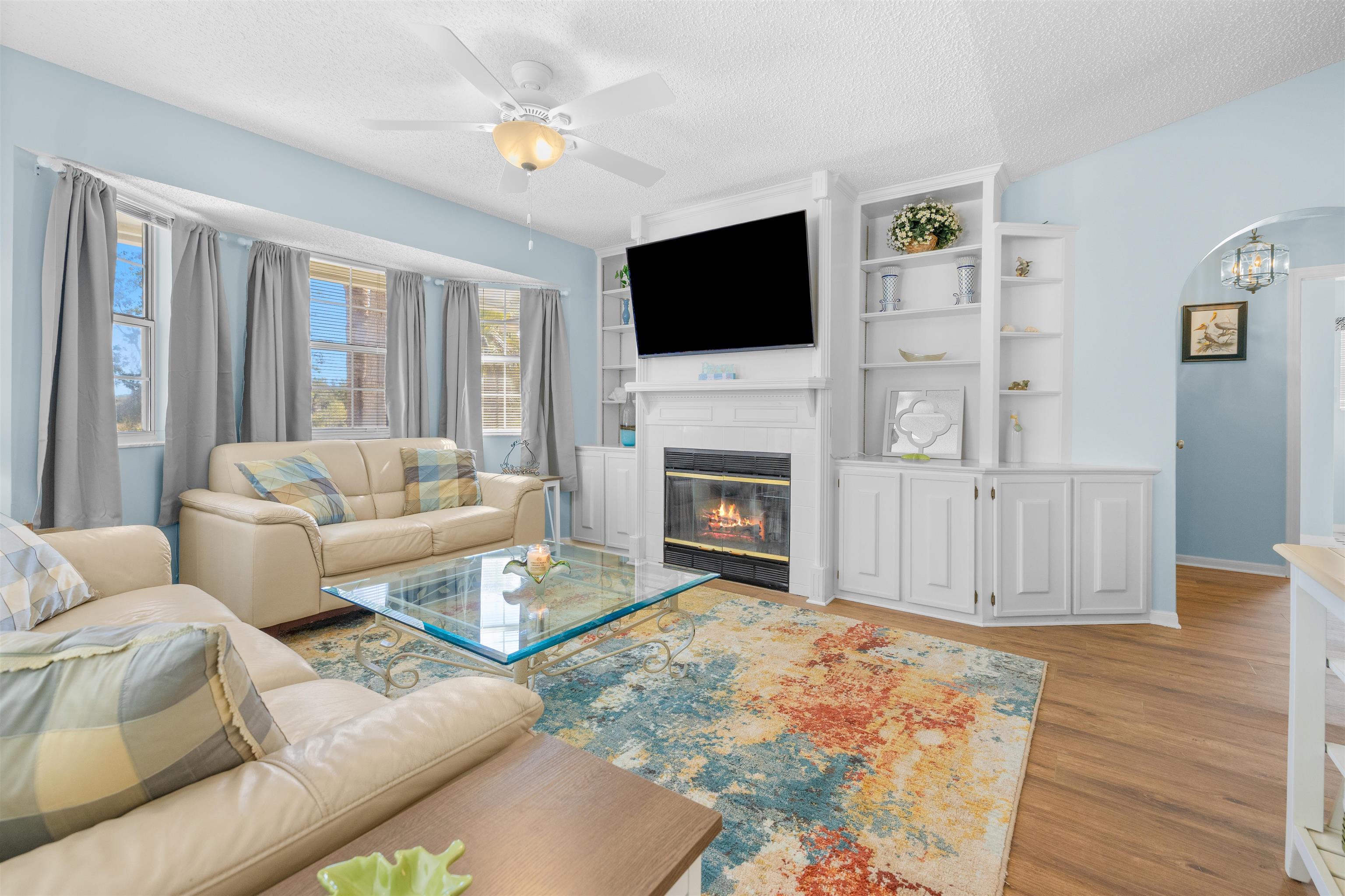 655 East Bianca Circle St. Augustine, FL 32086 - Photo 7 of 53 a living room with furniture a flat screen tv and a fireplace