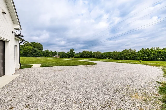 a view of a livingroom with wooden floor and furniture