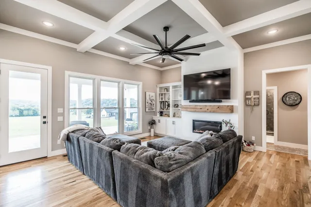 a living room with furniture fireplace and a flat screen tv