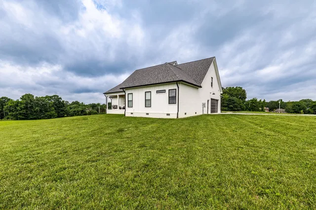 a kitchen with stainless steel appliances granite countertop a sink a stove and refrigerator