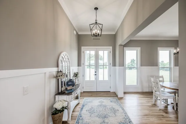 a kitchen with stainless steel appliances a dining table chairs stove and refrigerator
