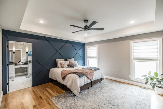 a bedroom with a bed and a large window with outer view