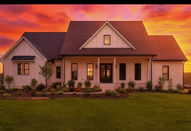 a front view of a house with a yard outdoor seating and garage