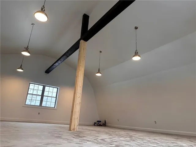 a view of empty room with window and ceiling fan