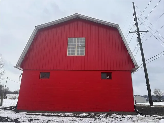 a view of a house with wooden wall and a window