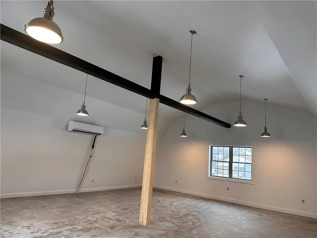 a view of empty room with window and ceiling fan