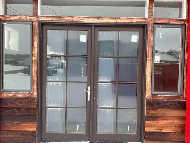 a kitchen with a refrigerator and wooden floor