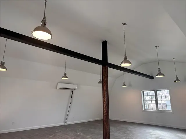 a view of a room with a windows and ceiling fan