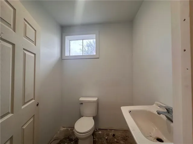 a white toilet sitting next to a bathroom sink